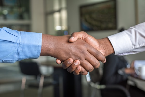 Professional business handshake representing payroll partnership